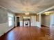 Open concept dining area with hardwood floors and a fireplace at 142 Swink Sw St, Concord, NC 28027