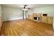 Bright living room with hardwood floors and a wood-paneled fireplace at 142 Swink Sw St, Concord, NC 28027