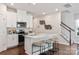 Modern kitchen with white cabinets, stainless steel appliances, and a kitchen island at 1618 Village Grove Ln, Monroe, NC 28110