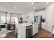 Modern kitchen with island, stainless steel appliances, and hardwood floors at 1618 Village Grove Ln, Monroe, NC 28110