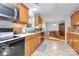 Bright kitchen with wood cabinets, tiled floor, and eat-in area at 1811 Charter Dr, Rock Hill, SC 29732