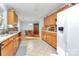 Bright kitchen with ample wood cabinets and tiled floor at 1811 Charter Dr, Rock Hill, SC 29732