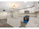 Modern kitchen with white cabinets, granite countertops, and a kitchen island at 2409 Crescent Ln, Gastonia, NC 28052