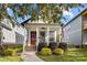 Cute cottage with a red door, brick steps, and well-manicured lawn at 511 E Main St, Rock Hill, SC 29730