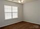 Well-lit bedroom with large window and brown carpet at 7374 Sun Dance Dr, Fort Mill, SC 29707