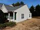 Tan home with green shutters and a side yard, showcasing exterior details at 7374 Sun Dance Dr, Fort Mill, SC 29707
