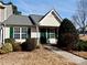 Inviting exterior of a charming tan home with green shutters and landscaping at 7374 Sun Dance Dr, Fort Mill, SC 29707