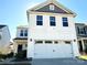 Two-story house with white siding, gray accents, and a two-car garage at 533 Copes Ct, Kannapolis, NC 28081