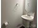 Small bathroom with pedestal sink and mirror at 533 Copes Ct, Kannapolis, NC 28081