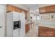 White refrigerator with a built-in coffee maker sits in this well-lit kitchen at 11716 Buckstone Ln, Charlotte, NC 28277