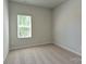 Simple bedroom with a window and neutral wall colors at 30 Woodsdale Se Pl, Concord, NC 28025