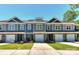 Three-unit townhome building, gray siding, white trim, and stone accents at 30 Woodsdale Se Pl, Concord, NC 28025