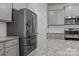 Stainless steel refrigerator and granite countertops highlight this kitchen at 3128 Mcgee Hill Dr, Charlotte, NC 28216