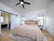 Spacious main bedroom with king-size bed, ensuite bathroom, and sliding barn door at 390 Cal Kennedy Rd, Cleveland, NC 27013