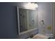 Bathroom with a white framed mirror, light blue walls, and updated vanity at 1091 Farm Pond Ln, Rock Hill, SC 29732
