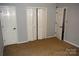 Spacious bedroom with neutral carpeting, double doors to closet, and additional door at 1091 Farm Pond Ln, Rock Hill, SC 29732