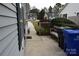 Small patio area with a bench and trash cans at 1091 Farm Pond Ln, Rock Hill, SC 29732