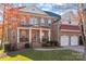 Two-story brick house with a three-car garage and inviting porch at 157 Montibello Dr, Mooresville, NC 28117