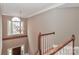 Elegant staircase with wooden railings and a chandelier above at 7517 British Gardens Ln, Charlotte, NC 28277