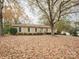 Brick ranch house with mature trees and a large yard at 1325 E Barden Rd, Charlotte, NC 28226