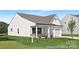 Side view of a charming white house with stone accents and covered porch at 219 Redondo Dr # 65P, Wingate, NC 28174