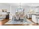 Bright dining room with hardwood floors and a view to the kitchen at 320 Three Greens Dr, Huntersville, NC 28078