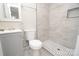 Clean bathroom with a shower/tub combo and gray vanity at 403 N Ransom St, Gastonia, NC 28052