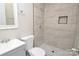 Clean bathroom with shower, toilet, and gray vanity at 403 N Ransom St, Gastonia, NC 28052