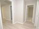 Hallway with light wood-look flooring, leading to bedrooms and bathroom at 403 N Ransom St, Gastonia, NC 28052
