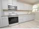 Modern kitchen with stainless steel appliances and light cabinets at 403 N Ransom St, Gastonia, NC 28052