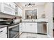 Modern kitchen with white cabinets, stainless steel appliances, and granite countertops at 6019 Heath Valley Rd, Charlotte, NC 28210