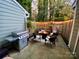 Cozy patio with fire pit, wicker furniture, and string lights at 6019 Heath Valley Rd, Charlotte, NC 28210