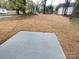 Large backyard with straw ground cover and a concrete patio at 640 Harry St, China Grove, NC 28023