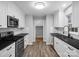 Updated kitchen featuring white shaker cabinets, black countertops, and stainless steel appliances at 922 Clover Park Dr, Clover, SC 29710