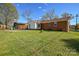 Large backyard with brick home and green lawn at 9313 Trinity Rd, Charlotte, NC 28216