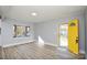 Living room with yellow door and hardwood floors at 9313 Trinity Rd, Charlotte, NC 28216