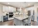 Spacious kitchen with granite island, stainless steel appliances, and white cabinets at 10174 Castlebrooke Dr, Concord, NC 28027