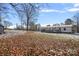 Large backyard with snow covered ground and leaf covered lawn at 174 Crosswhite Ln, Statesville, NC 28625