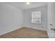 Well-lit bedroom featuring light wood-look floors at 2328 Danforth Ln, Charlotte, NC 28208