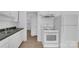 Kitchen featuring white appliances, a double sink, and wood-look flooring at 2328 Danforth Ln, Charlotte, NC 28208