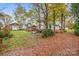 Large backyard with mature trees and a partially visible home at 421 Wiley Ave, Salisbury, NC 28144