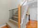 Elegant staircase with wooden railing and a safety gate at 4848 Kiser Island Dr, Terrell, NC 28682