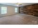 Spacious bedroom with wood accent wall and neutral carpeting at 7108 Kinley Commons Ln, Charlotte, NC 28278