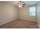 Bright bedroom with ceiling fan and neutral carpeting at 7108 Kinley Commons Ln, Charlotte, NC 28278