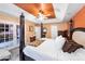 Bright bedroom with king-size bed and French doors leading to another room at 8619 Delamere Ln, Charlotte, NC 28269