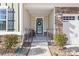 Inviting front porch with stone accents and a charming wreath at 10352 Black Locust Ln, Charlotte, NC 28215