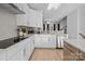 White kitchen with stainless steel appliances and gray tile backsplash at 13020 Moon Rd # 45, Charlotte, NC 28277