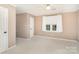 Spacious bedroom with neutral walls and carpet, featuring a large window and ample closet space at 249 Beech Brook Ln, Statesville, NC 28625