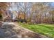 House exterior with attached garage and long driveway, surrounded by trees at 249 Beech Brook Ln, Statesville, NC 28625