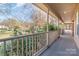 Covered front porch with wooden railing offering views of the neighborhood at 249 Beech Brook Ln, Statesville, NC 28625